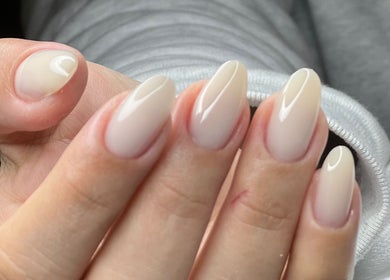 Close-up of elegant nude almond nails from MAIDELIN BEAUTY & SPA, Miami, Florida, US.
