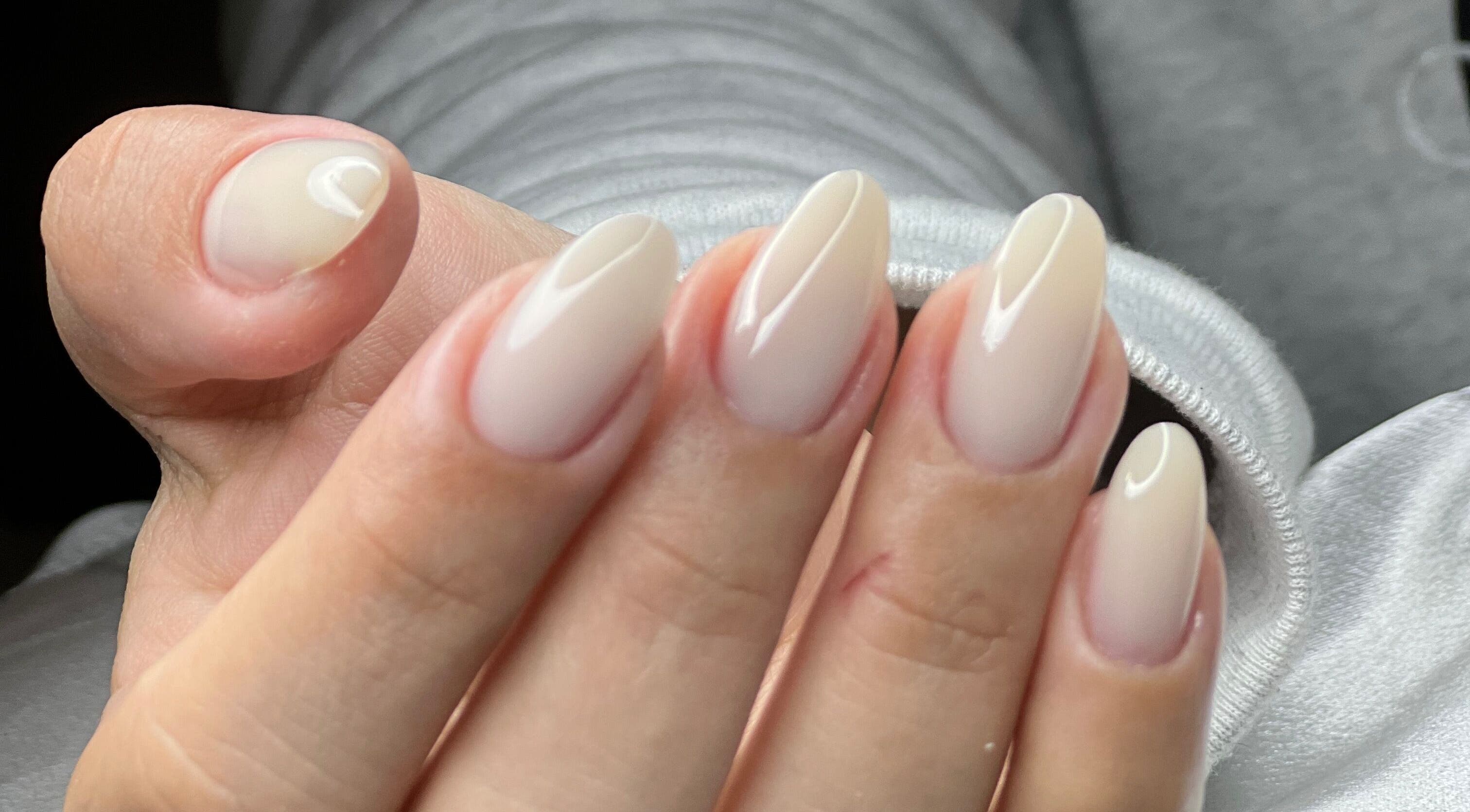 Close-up of elegant nude almond nails from MAIDELIN BEAUTY & SPA, Miami, Florida, US.