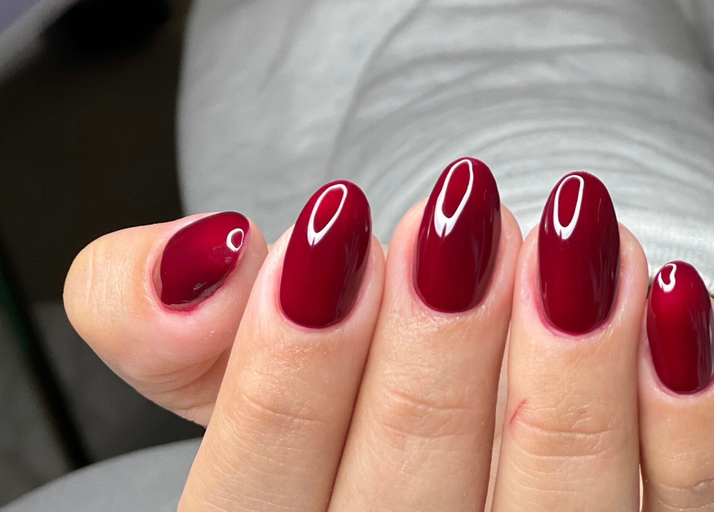 Elegant crimson nails at MAIDELIN BEAUTY & SPA, Miami, Florida, US. Perfect for any occasion.