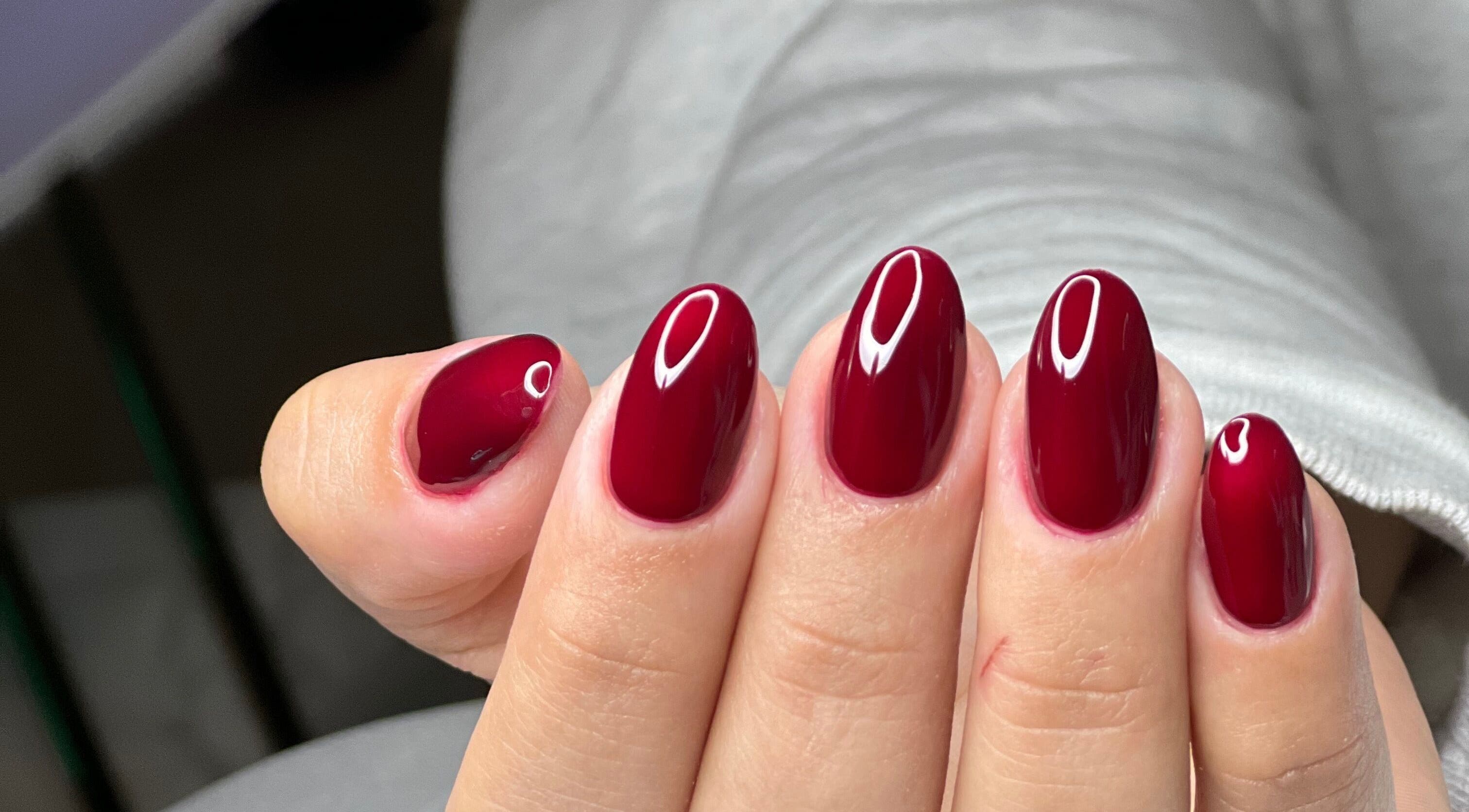 Elegant crimson nails at MAIDELIN BEAUTY & SPA, Miami, Florida, US. Perfect for any occasion.