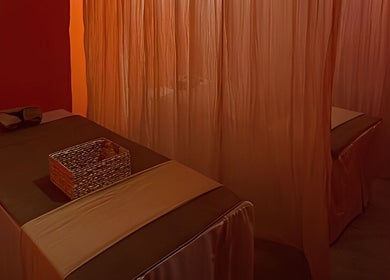 Tranquil massage room at Tê Spa, Đà Nẵng, Đà Nẵng, VN with elegant curtains and relaxing ambiance.