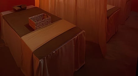 Tranquil massage room at Tê Spa, Đà Nẵng, Đà Nẵng, VN, featuring warm lighting and comfortable tables.