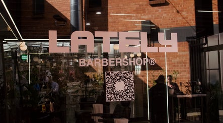 Front window of Rocky - Lately Barbershop in Bowden, South Australia, AU with logo and QR code.