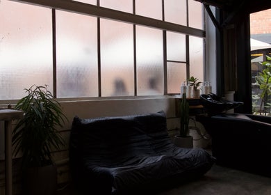 Cozy lounge area at Rocky - Lately Barbershop, Bowden, South Australia, AU with plants and modern seating.
