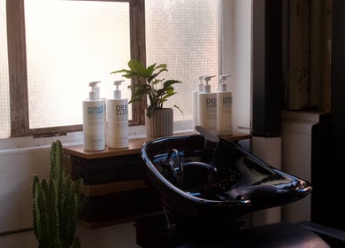 Shampoo station at Rocky - Lately Barbershop, Bowden, South Australia showcasing products and greenery.