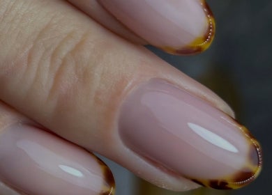 Elegant nail art at Gnb Nail Studio in Broomfield, England, GB featuring glossy pink nails with brown accents.