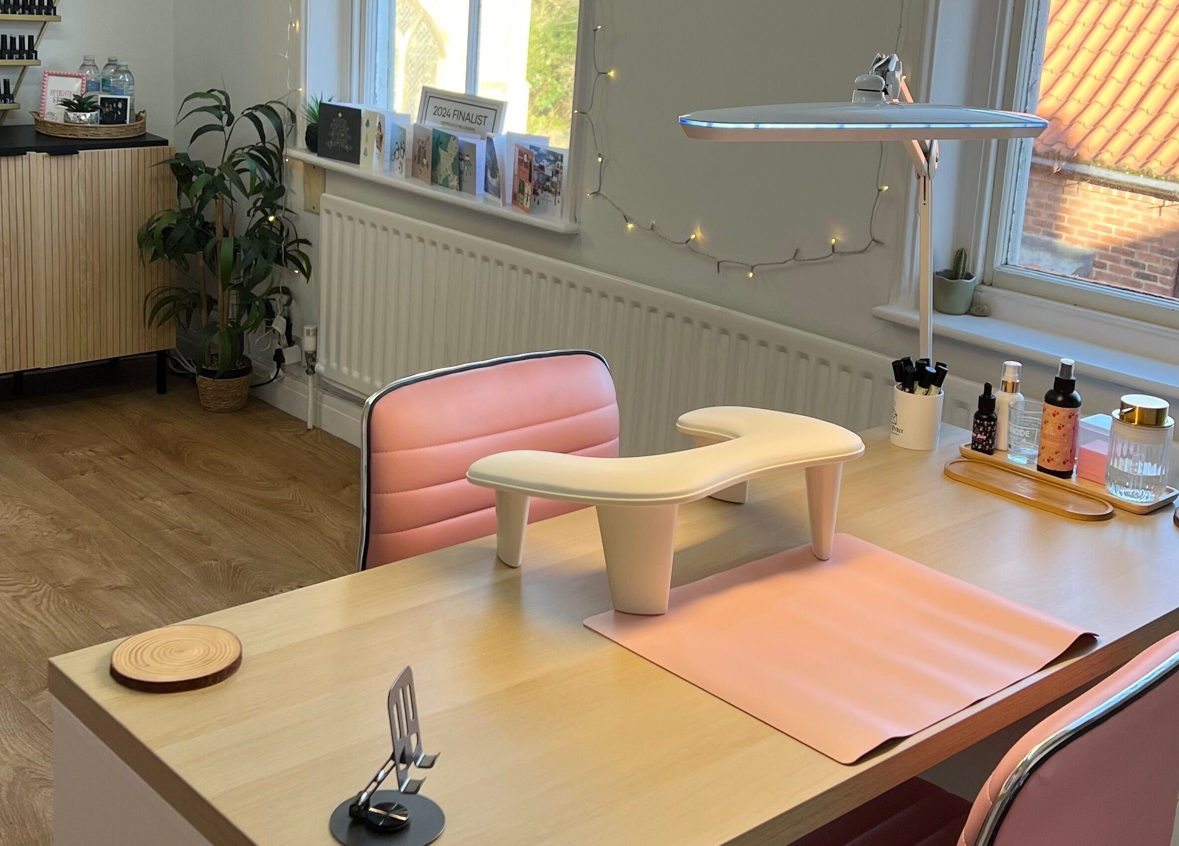 Chic nail studio interior at Rockets Nails by Vicki, Beverley, England, GB featuring pink chairs and nail essentials.