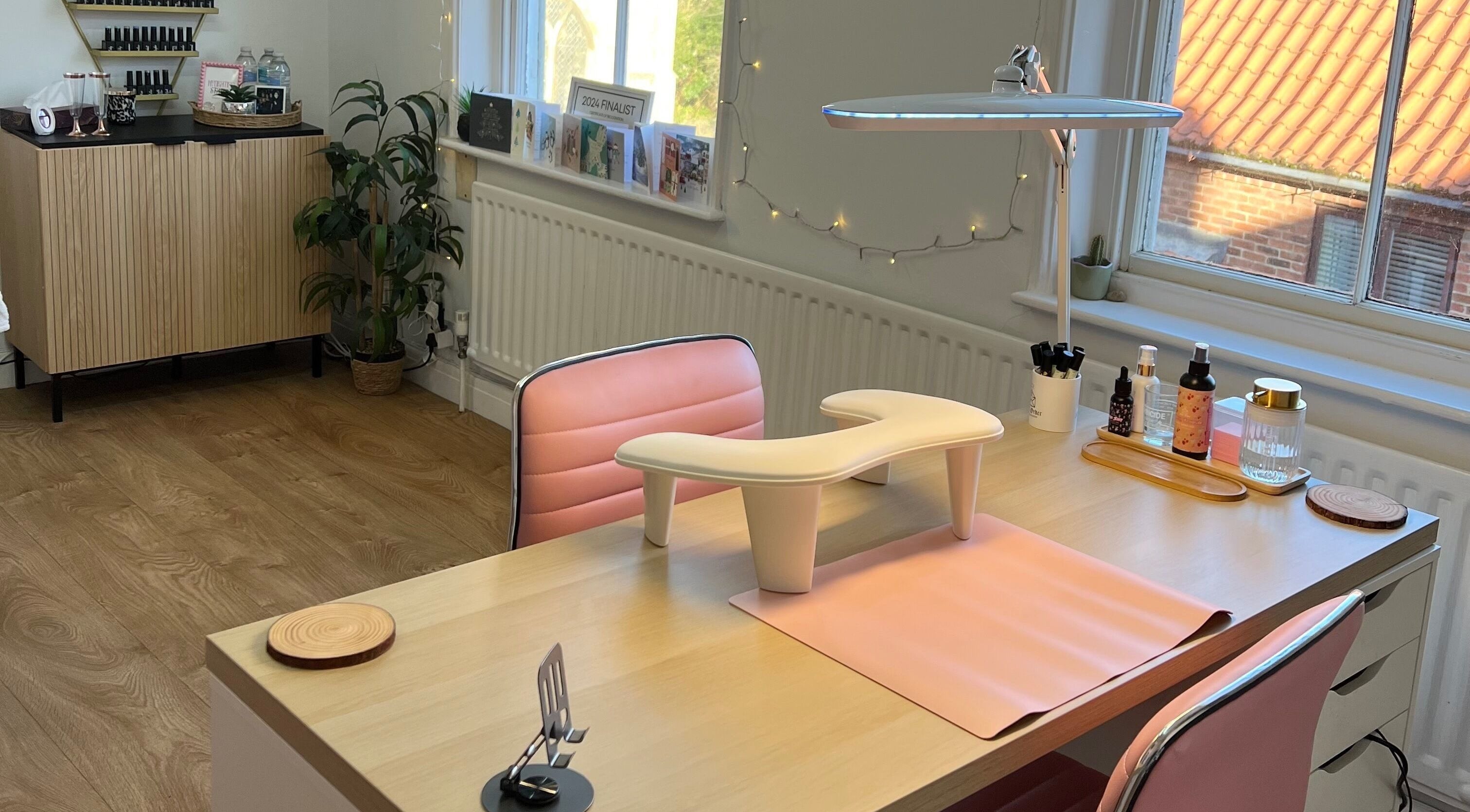 Chic nail studio interior at Rockets Nails by Vicki, Beverley, England, GB featuring pink chairs and nail essentials.