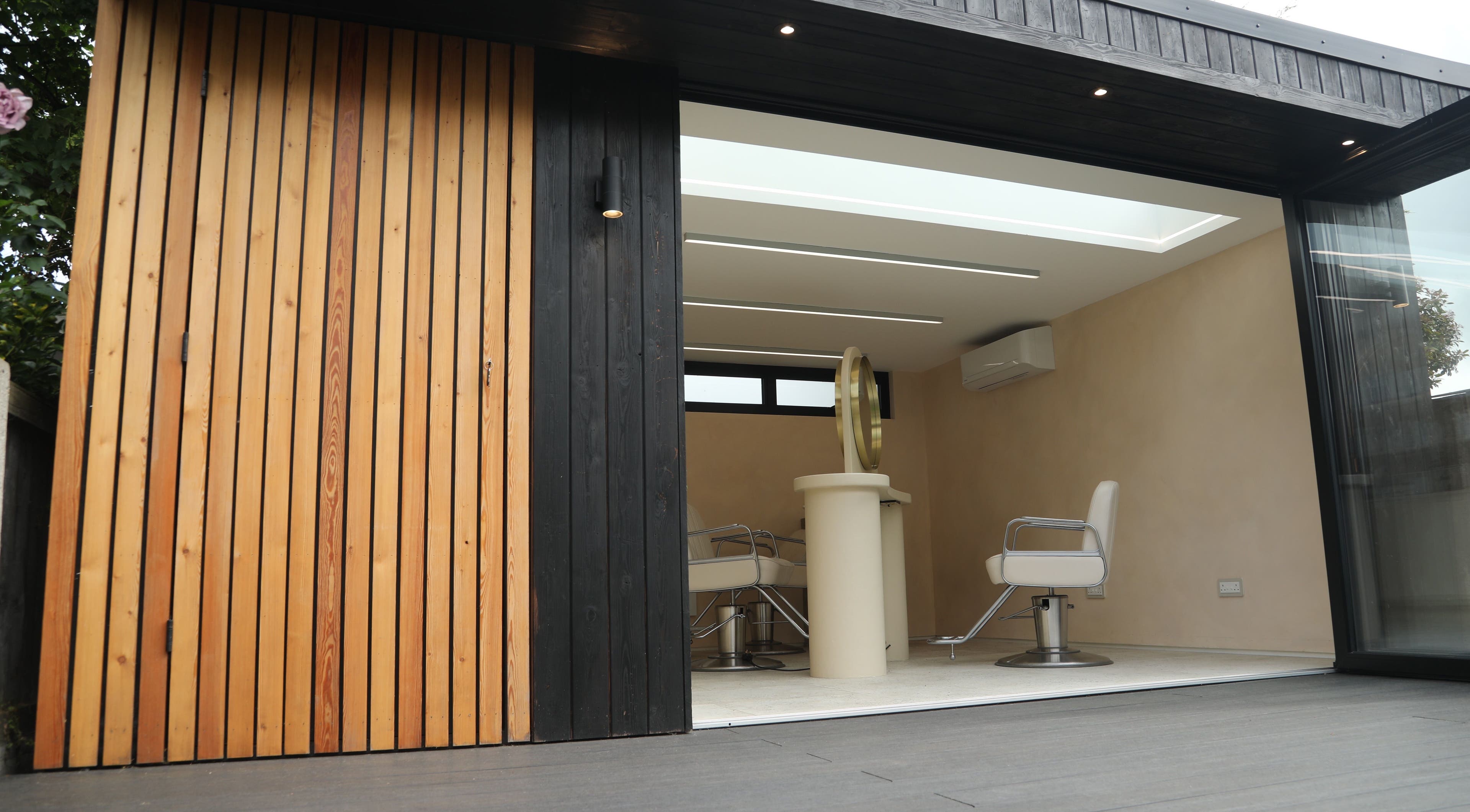 Sleek salon chairs inside District Salon, Southend-on-Sea, England, GB, showcasing modern design with wooden paneling.
