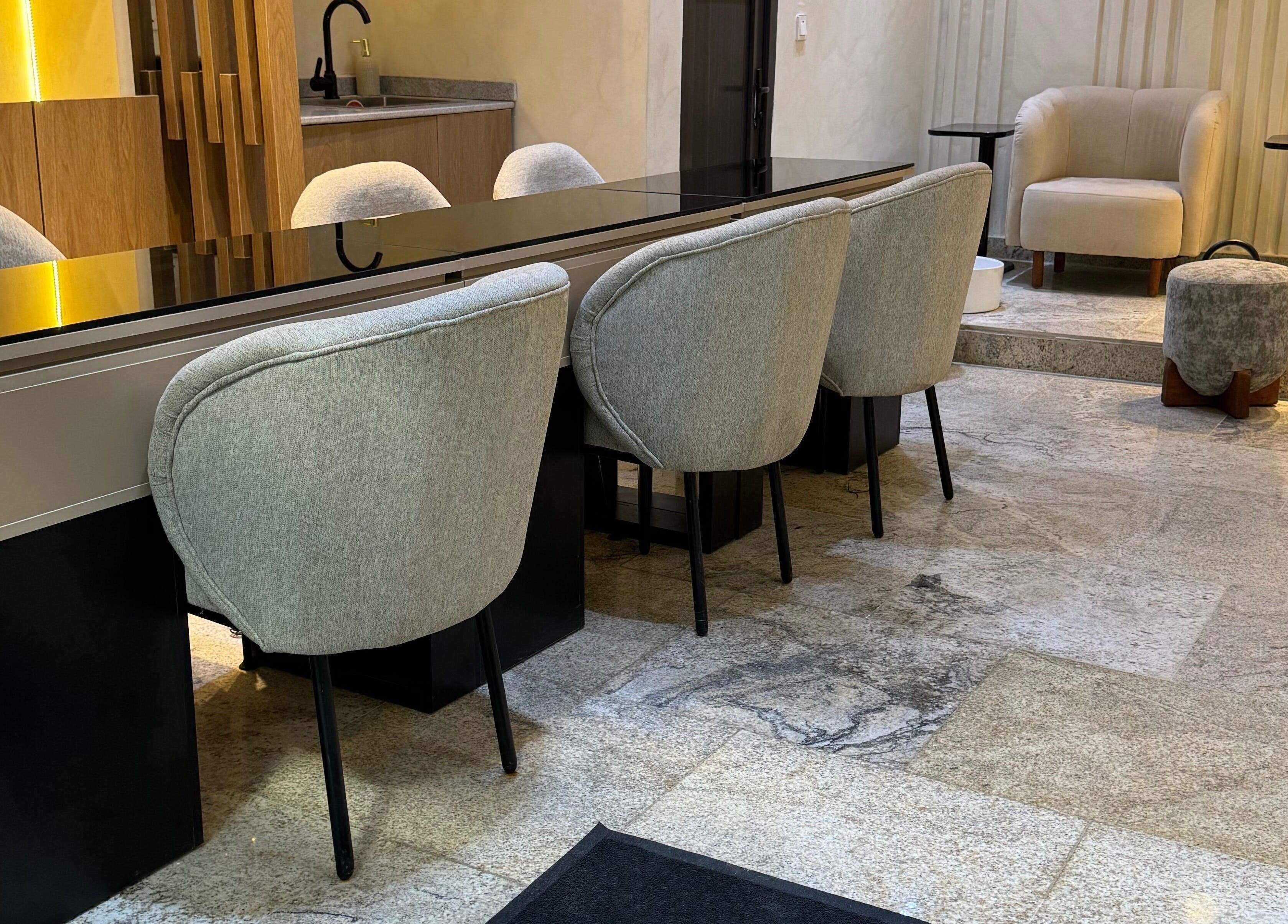 Modern seating area at The Nail Lab, Abuja, Federal Capital Territory, NG, with stylish chairs and sleek decor.
