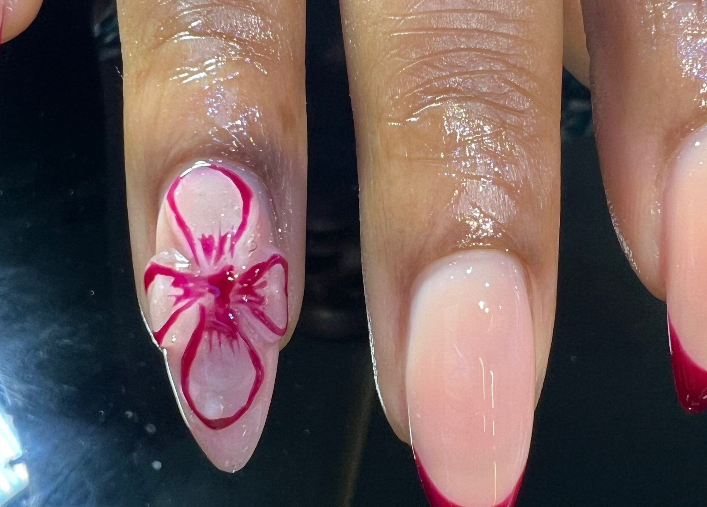 Elegant nail art featuring pink floral design at The Nail Lab in Abuja, Federal Capital Territory, NG.