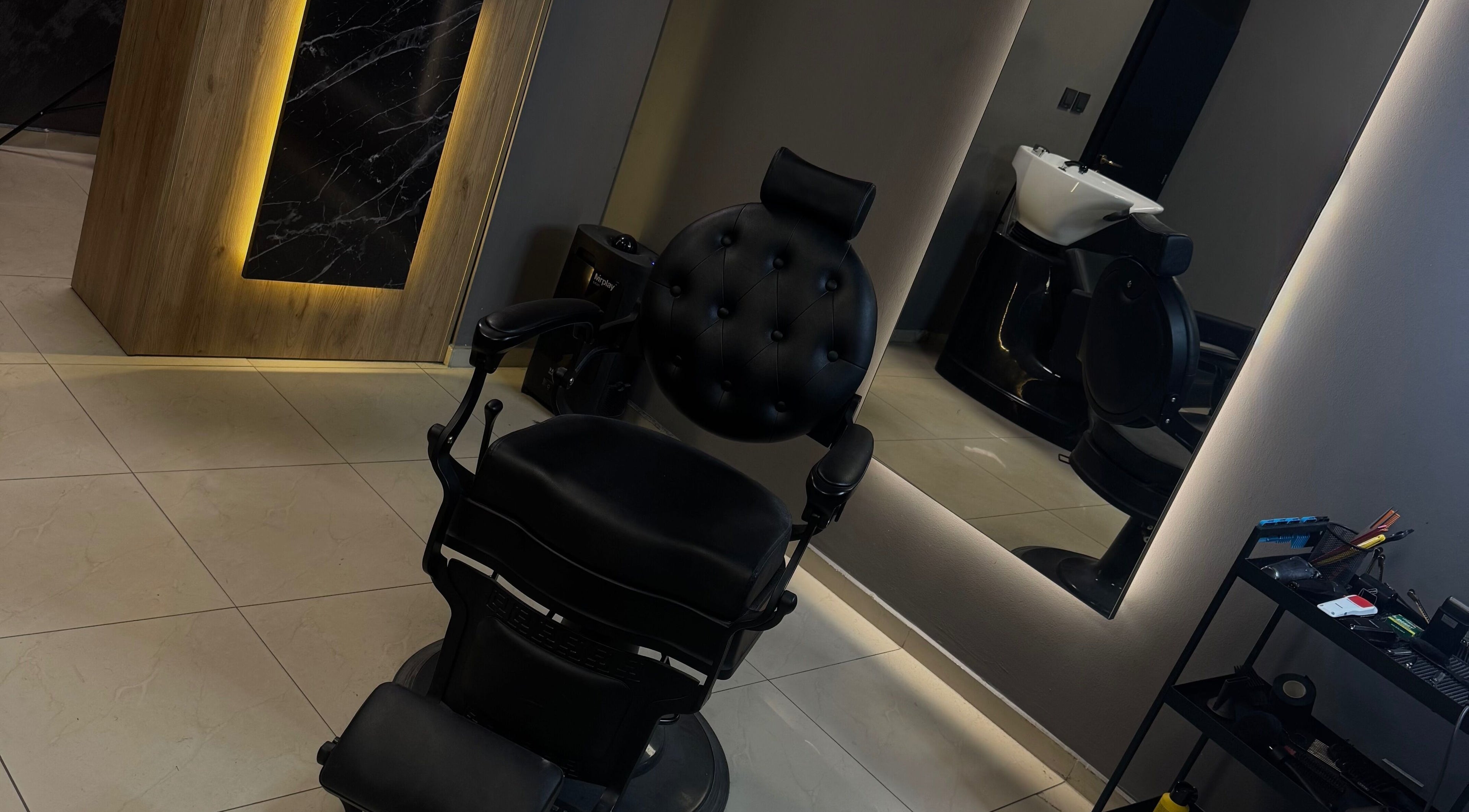 Elegant styling chair at eleven barber studio in Varna, Varna, BG with modern mirror setup.