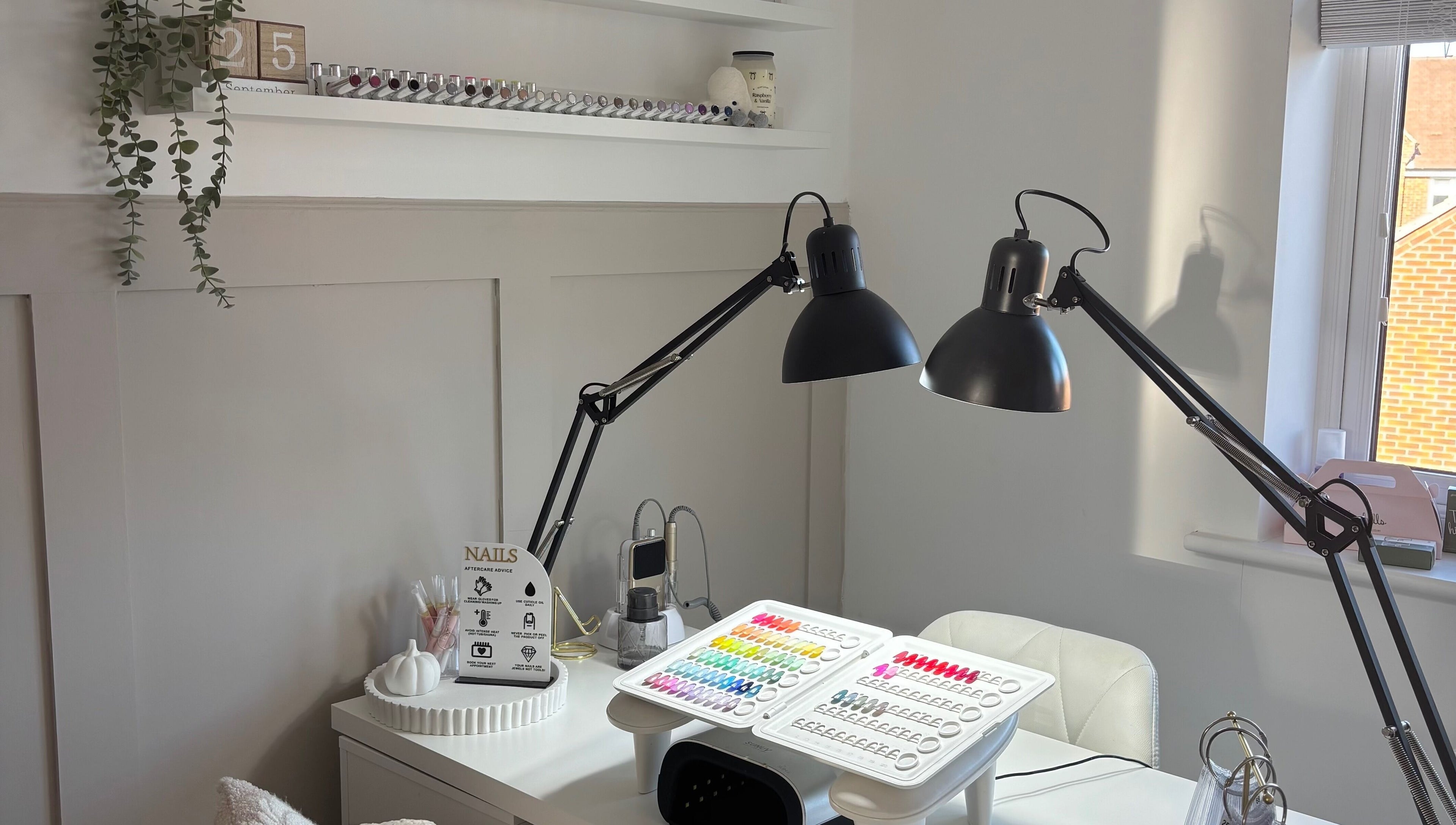 Chic nail workstation at By Lucy Ellenx, Stratford-upon-Avon, England, GB with colorful polish display.