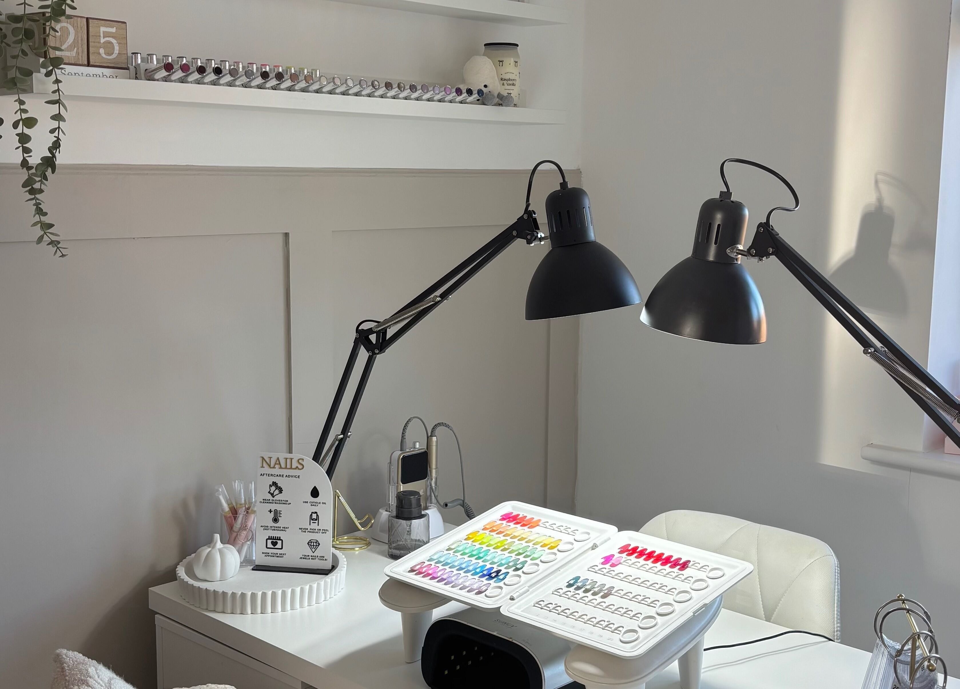 Chic nail workstation at By Lucy Ellenx, Stratford-upon-Avon, England, GB with colorful polish display.