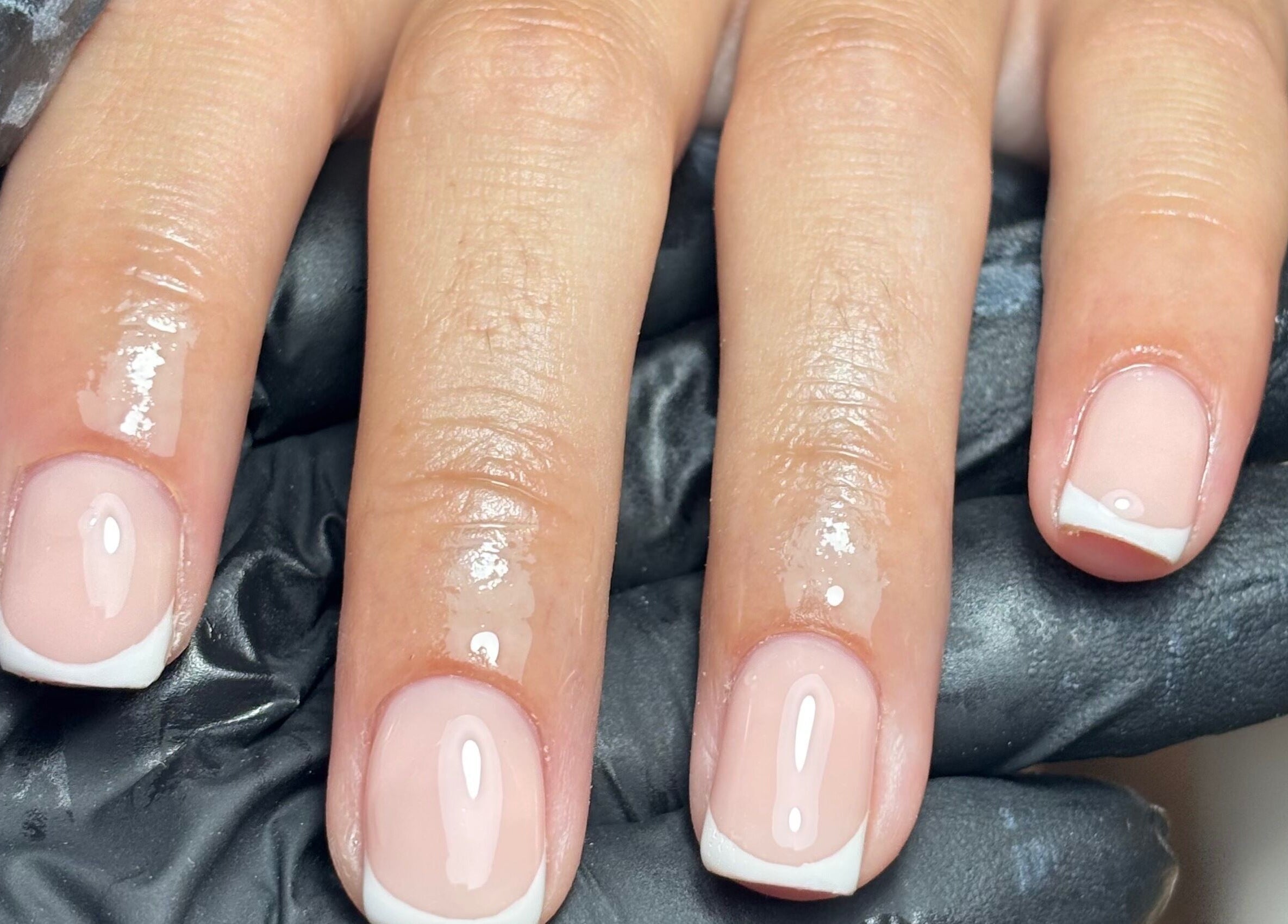 French manicure by By Lucy Ellenx in Stratford-upon-Avon, England, GB. Close-up of freshly painted nails.