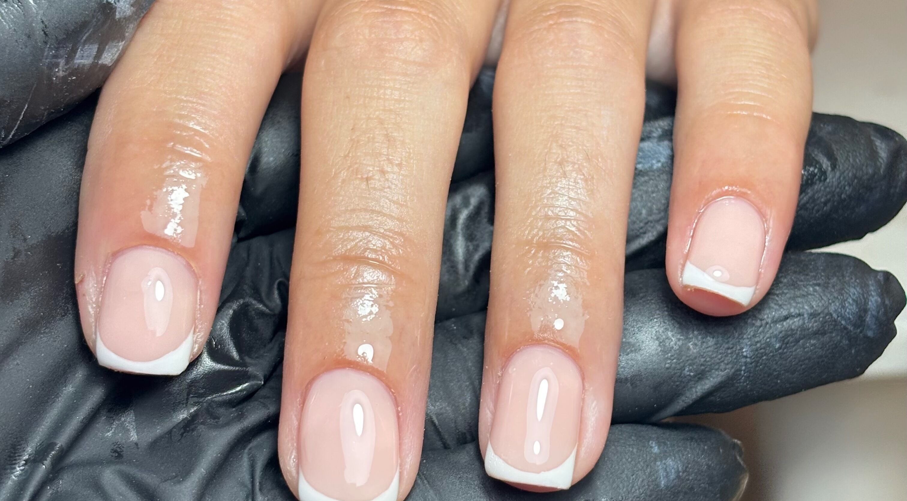 French manicure by By Lucy Ellenx in Stratford-upon-Avon, England, GB. Close-up of freshly painted nails.