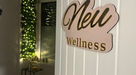 Neu Beauty Salon entrance with illuminated sign in Newport, Wales, GB, exuding a warm and inviting atmosphere.
