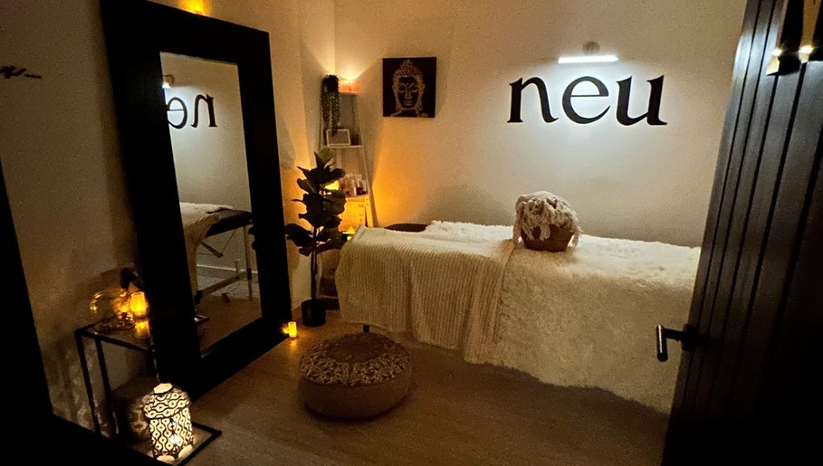 Cozy treatment room at Neu Beauty Salon, Newport, Wales, GB with soft lighting and plush decor.