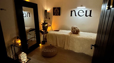 Cozy treatment room at Neu Beauty Salon, Newport, Wales, GB with soft lighting and plush decor.