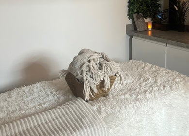 Plush spa bed with soft blankets at Neu Beauty Salon, Newport, Wales, GB, creating a serene relaxation setting.