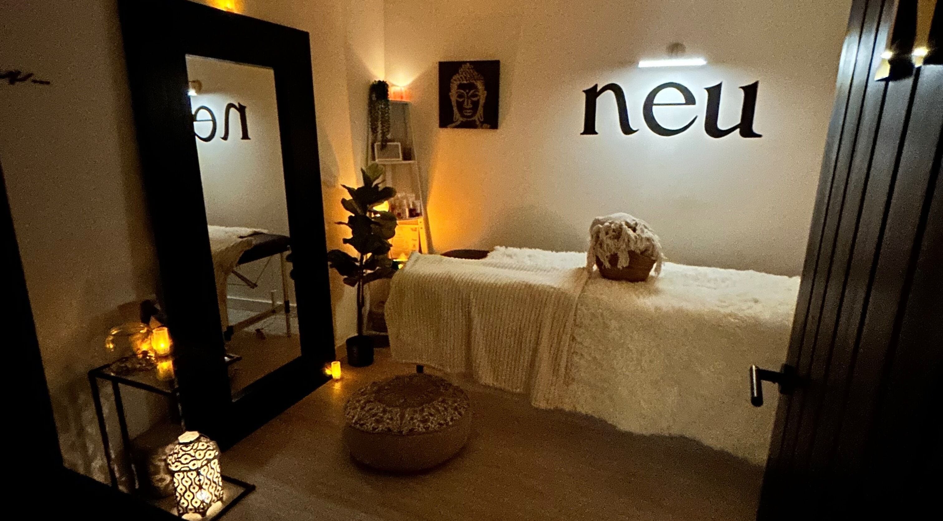 Calming therapy room at Neu Beauty Salon, Newport, Wales, GB with warm lighting and elegant decor.