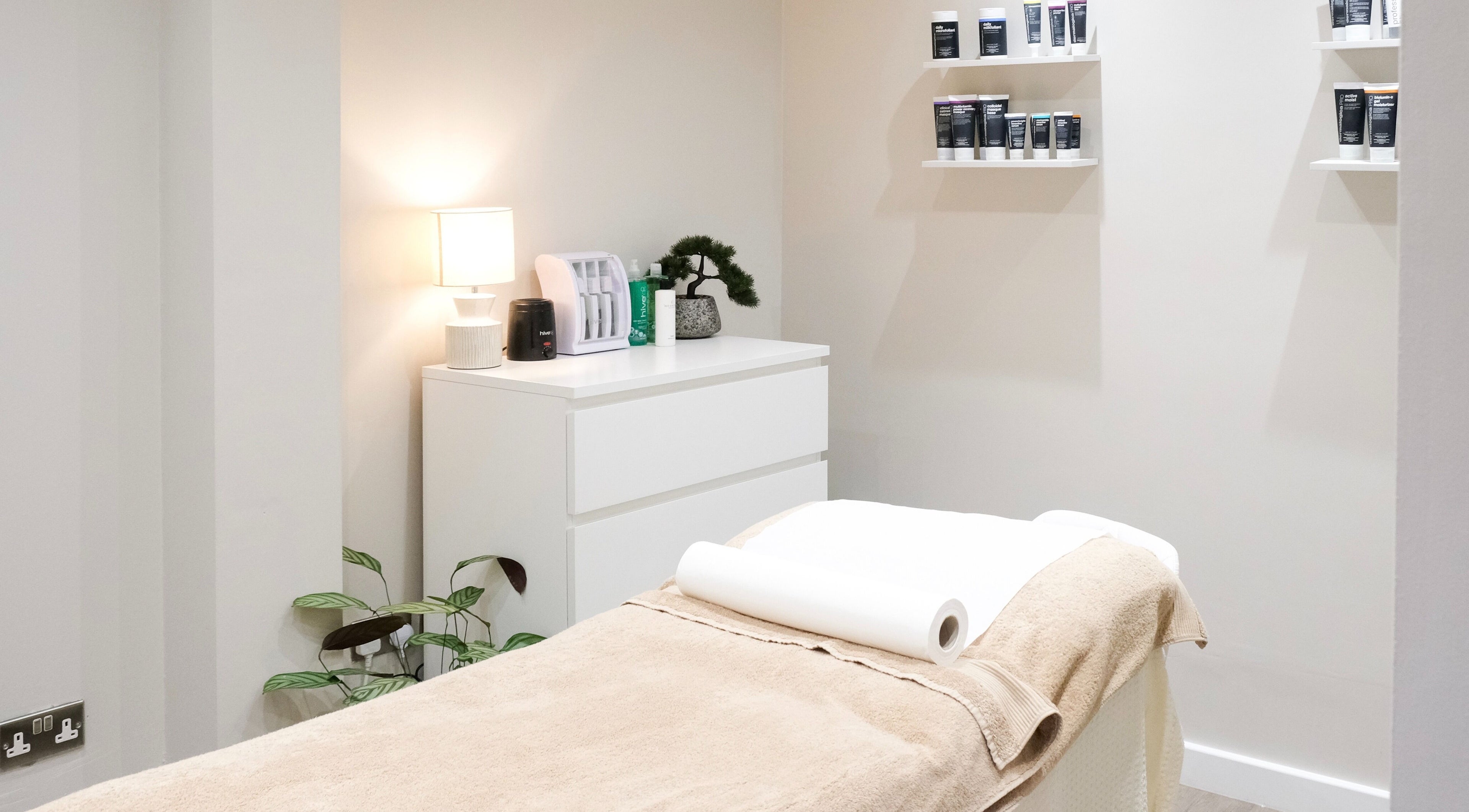 Tranquil treatment room at Nova, Clitheroe, England, GB with a cozy massage table and soothing decor.