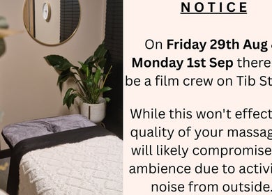Peaceful massage room at Bee Revived, Manchester, England, GB with a notice about filming activity.