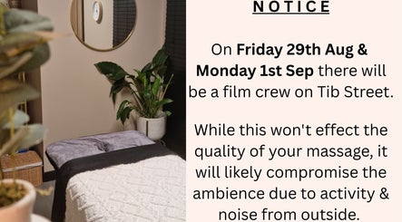 Peaceful massage room at Bee Revived, Manchester, England, GB with a notice about filming activity.