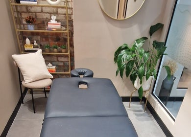 Tranquil massage room at Bee Revived, Manchester, England, GB with elegant decor and greenery.