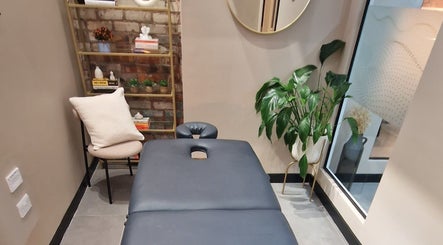 Tranquil massage room at Bee Revived, Manchester, England, GB with elegant decor and greenery.