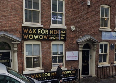 Exterior of Bee Revived in Manchester, England, GB showcasing waxing services signage.