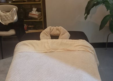 Cozy massage room at Bee Revived in Manchester, England, GB, featuring a plush massage bed.