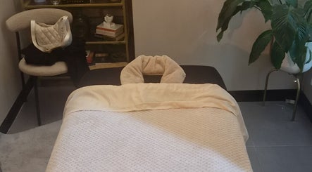 Cozy massage room at Bee Revived in Manchester, England, GB, featuring a plush massage bed.