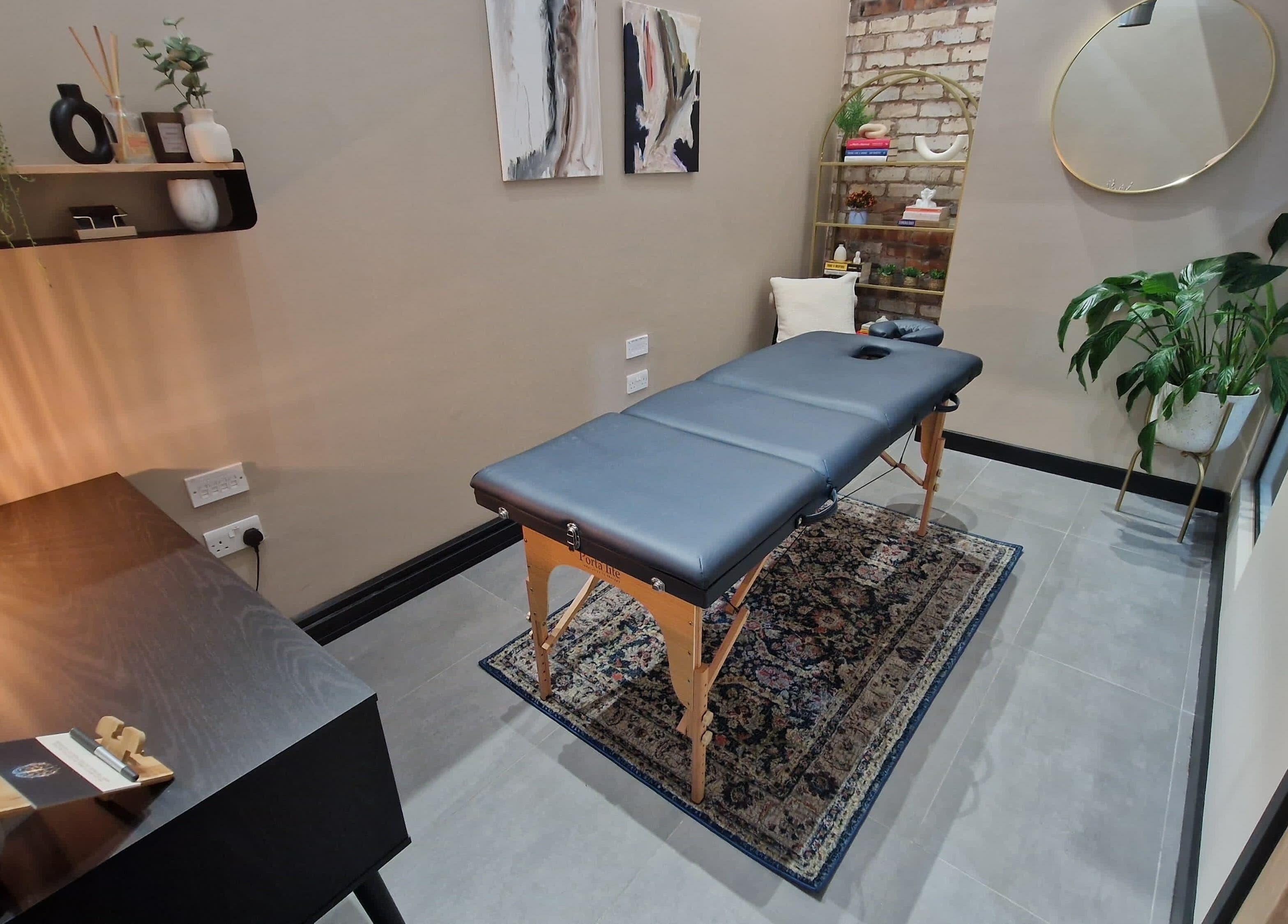 Cozy massage room at Bee Revived, Manchester, England, GB with a massage table and calming decor.