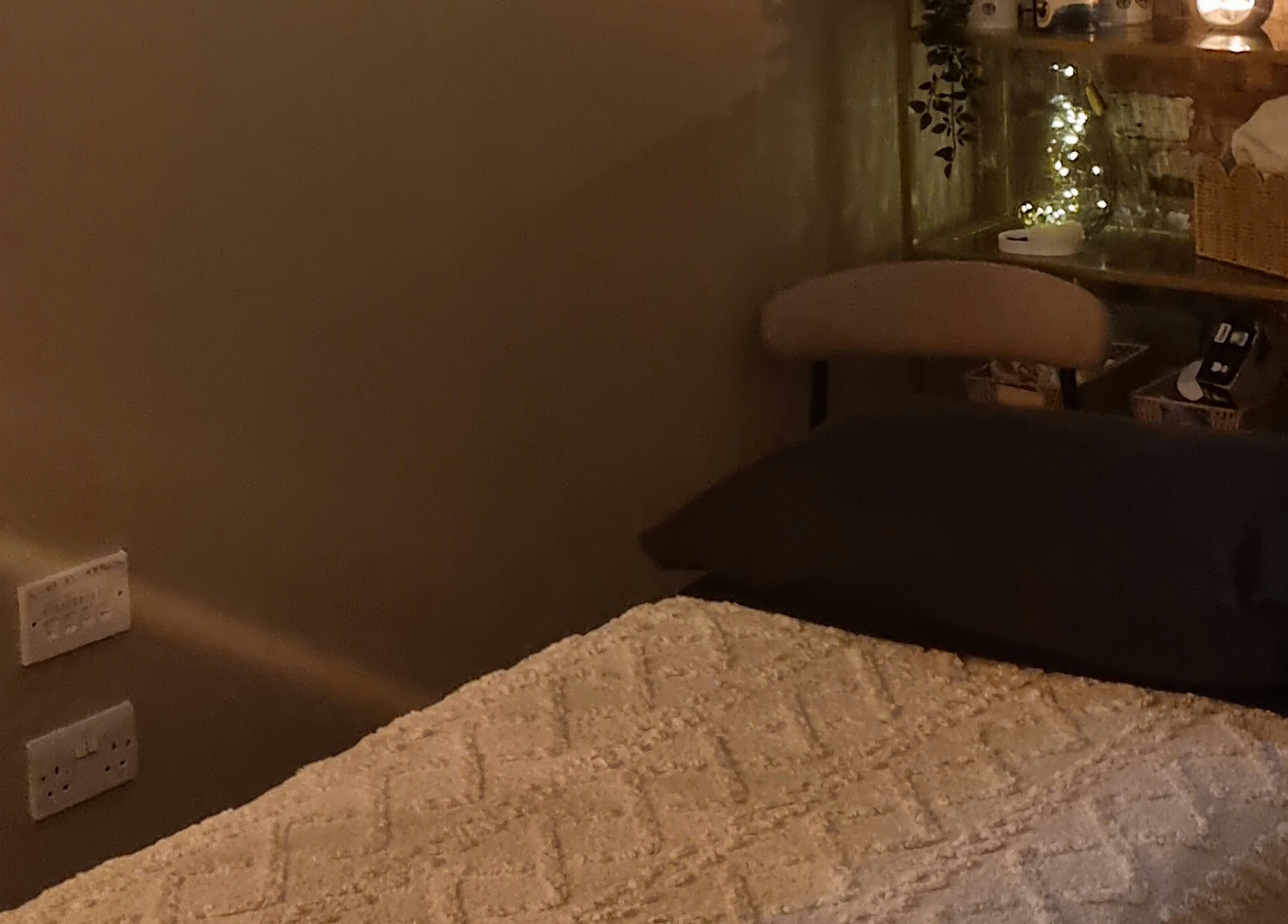 Relaxing treatment area at Bee Revived, Manchester, England, GB, with warm lighting and plush bedding.