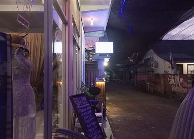 Entrance of Gili Mo Beauty Spa & Hair Salon in Nusa Tenggara Barat, ID, warmly lit at dusk.
