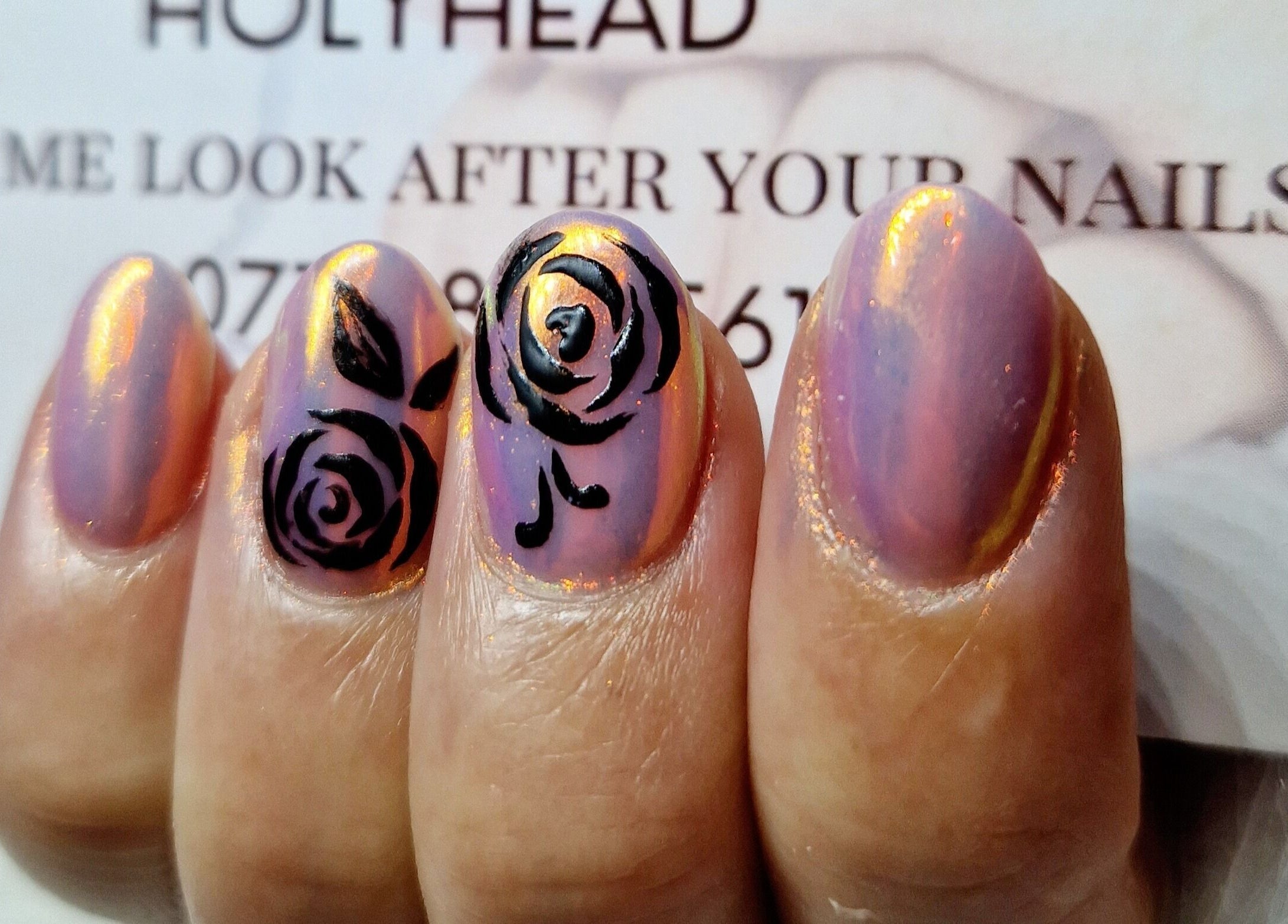 Rose-patterned nails with shimmering finish at Fantasy Nails, Holyhead, Cymru, GB.