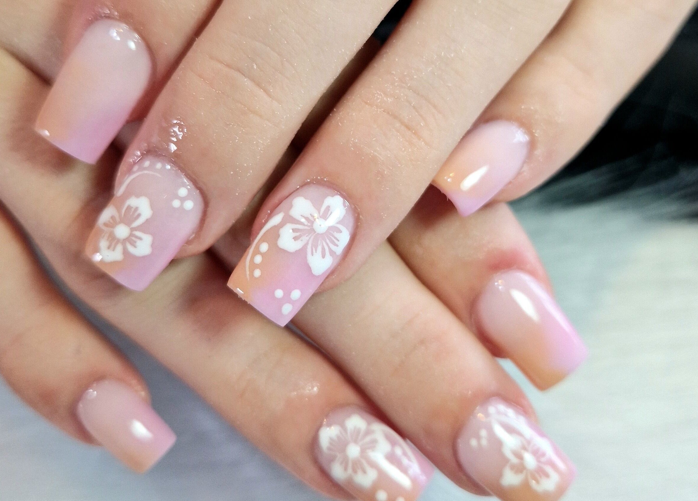 Elegant floral nail art at Fantasy Nails, Holyhead, Cymru, GB showcases delicate pink designs.