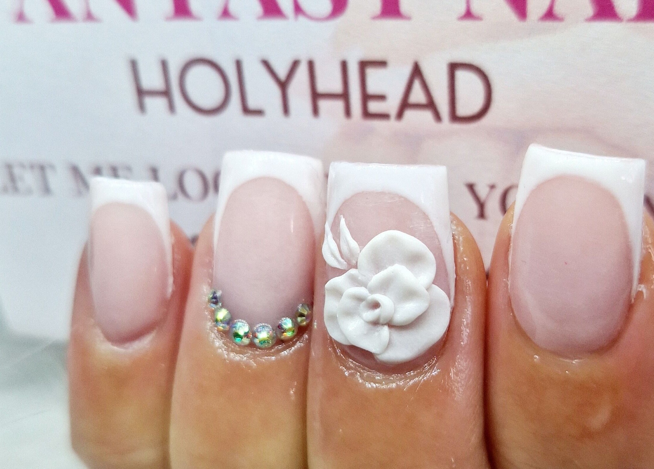 Elegant nail art with floral and gem designs at Fantasy Nails, Holyhead, Cymru, GB.