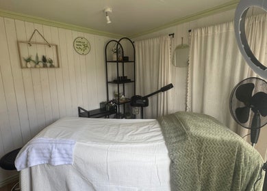 Calm treatment room at Livella Skin, Chester, England, GB, featuring a cozy massage bed and elegant décor.