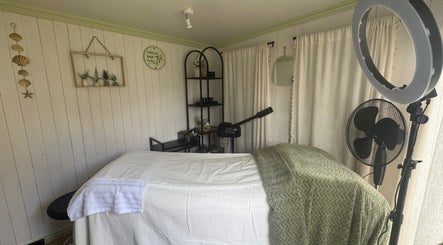 Calm treatment room at Livella Skin, Chester, England, GB, featuring a cozy massage bed and elegant décor.
