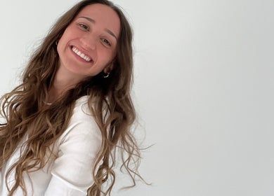 Smiling person with long, wavy hair at Aesthete, Hyrum, Utah, US. Effortless beauty and joy captured perfectly.