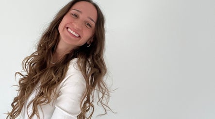 Smiling person with long, wavy hair at Aesthete, Hyrum, Utah, US. Effortless beauty and joy captured perfectly.