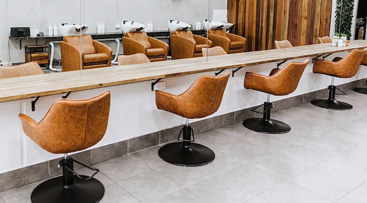 Elegant styling stations at Soho Hair Salon in Narellan, New South Wales, AU, featuring modern leather chairs.
