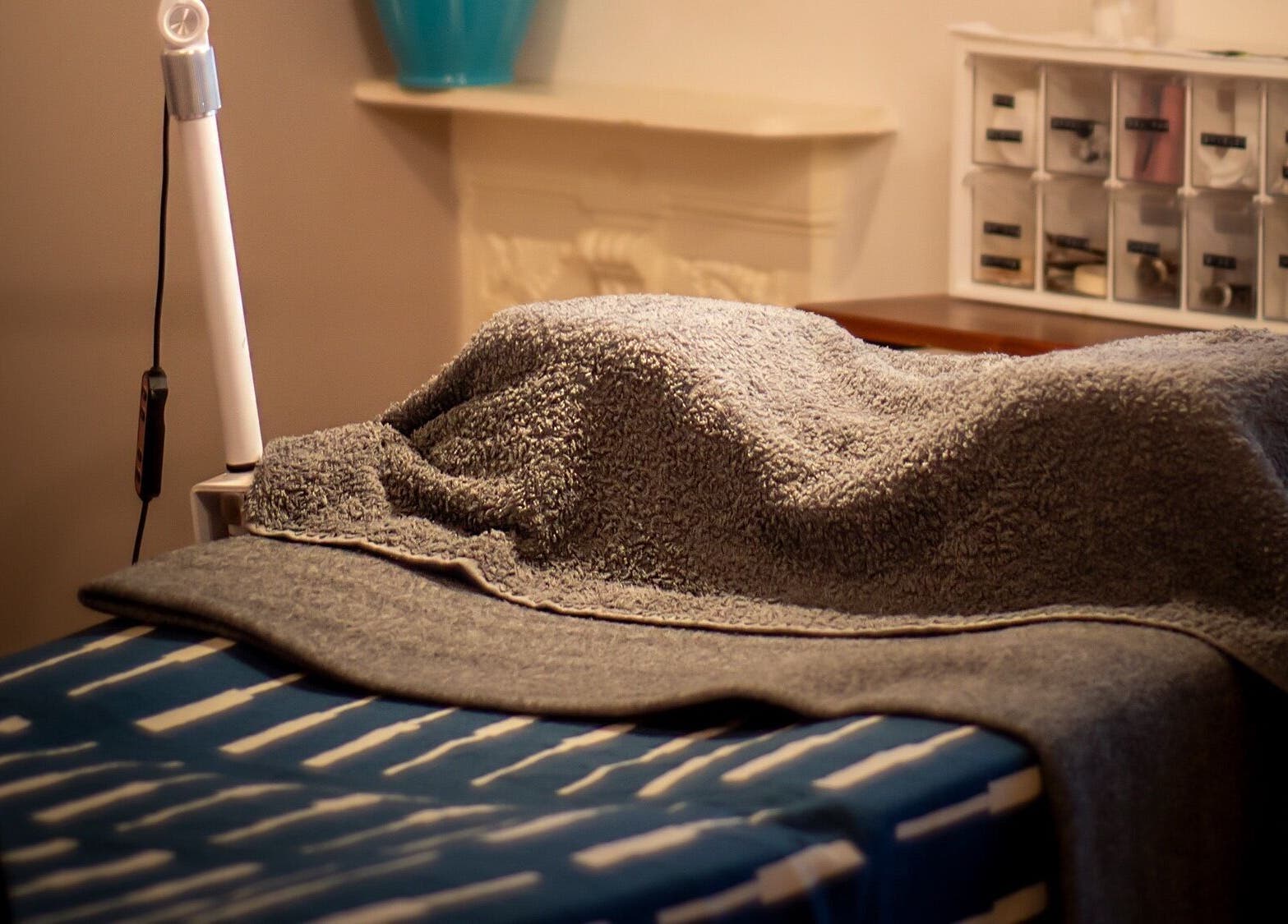 A relaxing treatment bed with cozy towels at Kanti Studio in Colwick, England, GB.