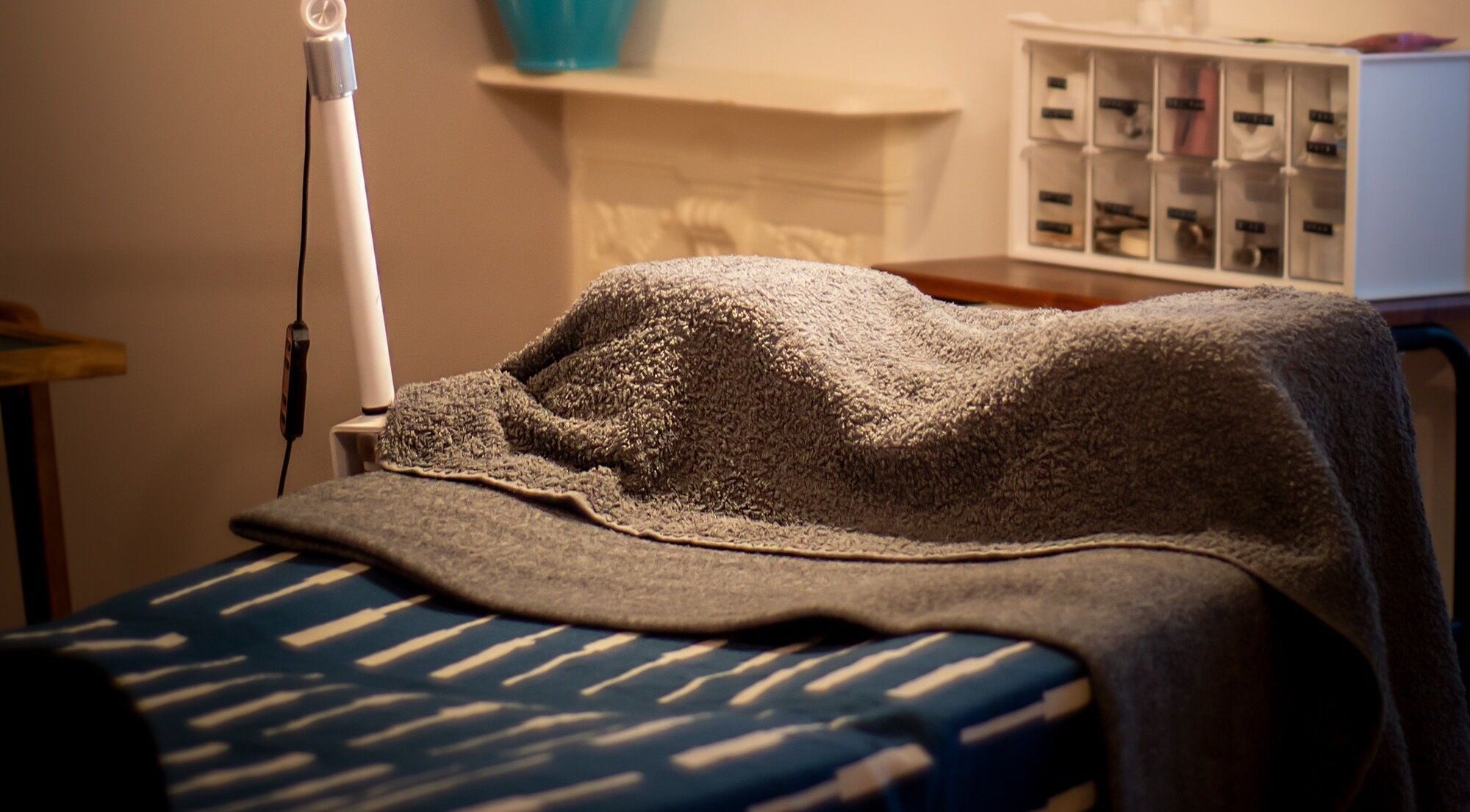 A relaxing treatment bed with cozy towels at Kanti Studio in Colwick, England, GB.