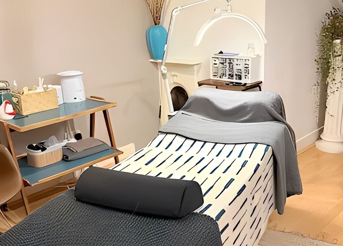 Relaxing treatment room at Kanti Studio in Colwick, England, GB with massage table and decor.