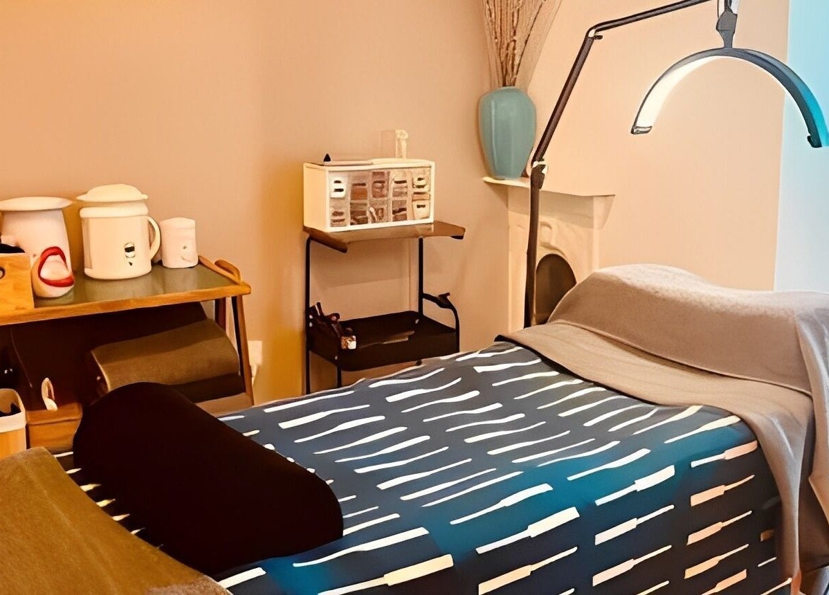 Relaxing massage room at Kanti Studio, Colwick, England, GB, featuring a comfortable treatment bed and cozy ambiance.