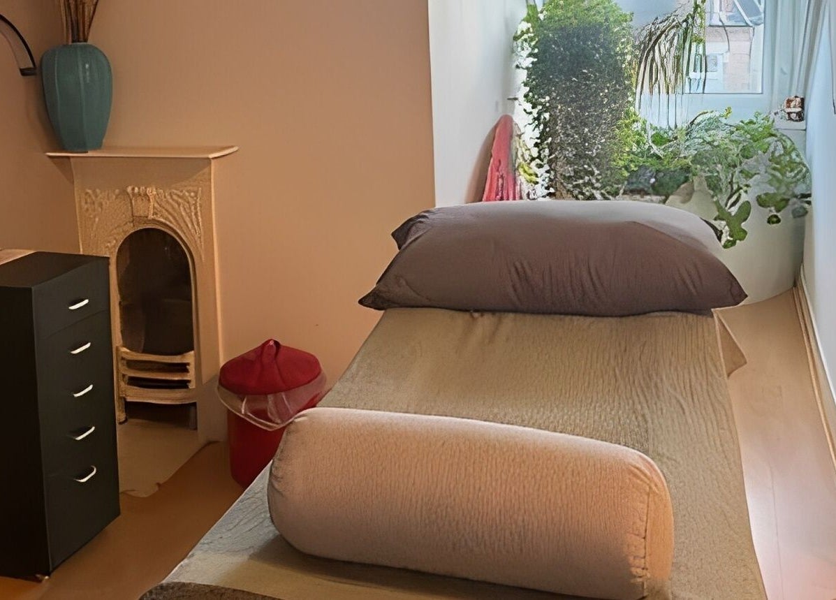 Tranquil therapy room at Kanti Studio, Colwick, England, GB, featuring a massage table and lush greenery.