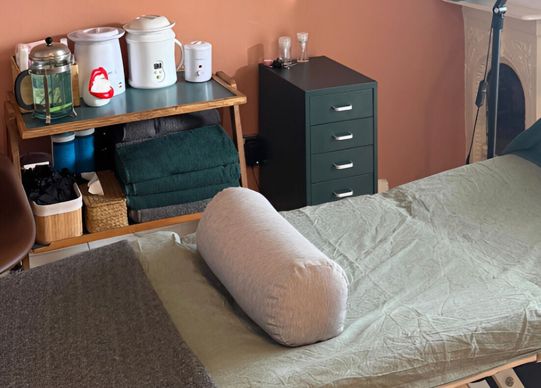 Massage table and essential oils at Kanti Studio in Colwick, England, GB, ready for a relaxing session.